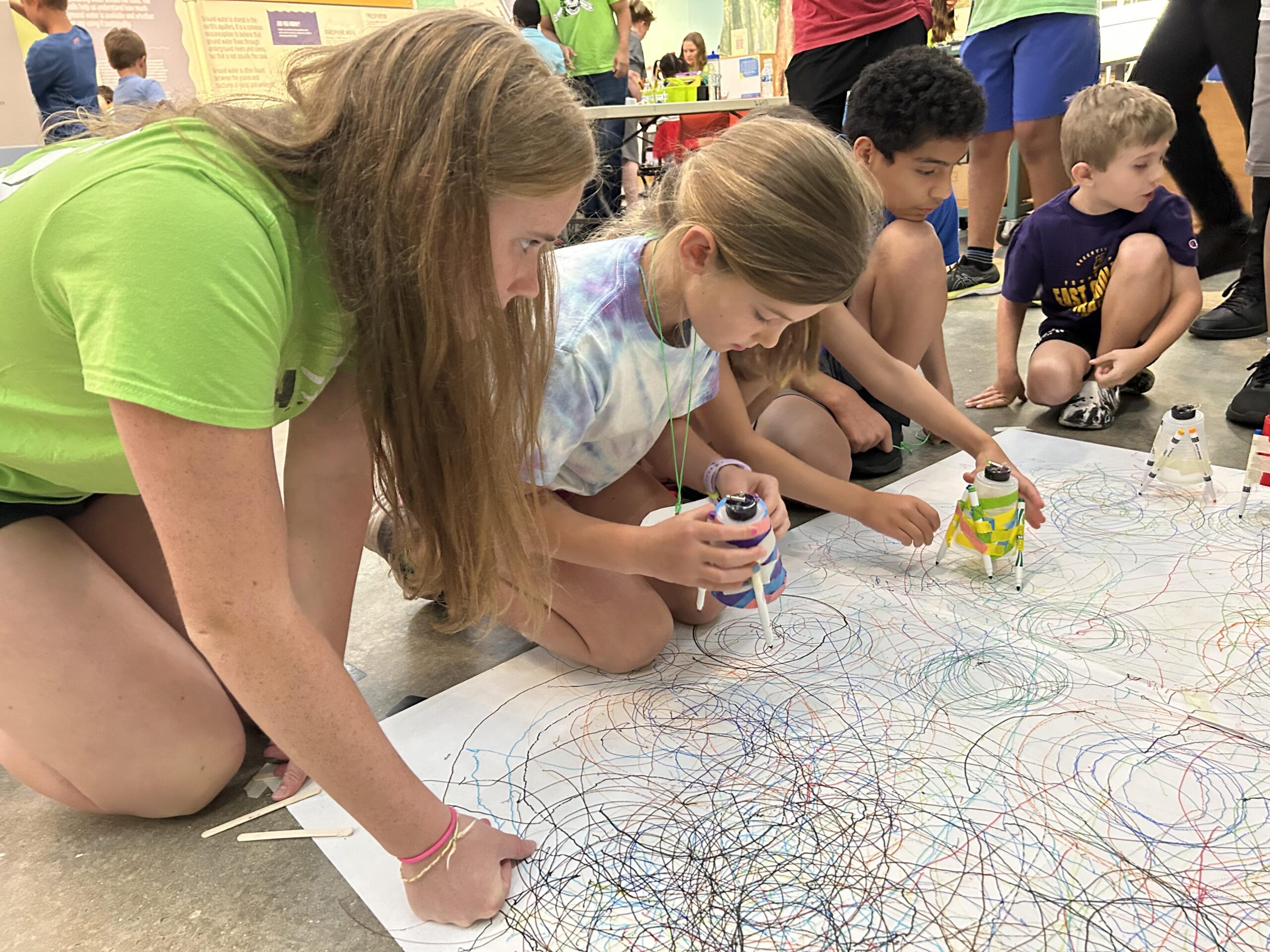 Kids playing with doodlebot robots